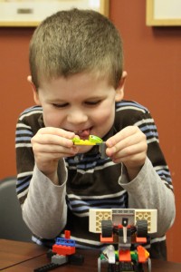 Young LEGO builder with creation